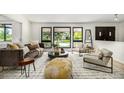 Bright living room featuring modern furniture, large windows, and stylish decor at 7234 S Kendall Ct, Littleton, CO 80128