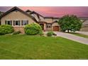 Charming two-story home with a lush green lawn and mature tree, offering curb appeal and a welcoming atmosphere at 14370 Osage St, Westminster, CO 80023