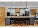 Spacious kitchen featuring a large island, stainless steel appliances, and modern lighting fixtures at 14370 Osage St, Westminster, CO 80023