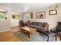 Inviting living space featuring hardwood floors, neutral walls, and comfortable seating, ideal for relaxation and gatherings at 14050 E 25Th Pl, Aurora, CO 80011