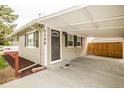 Charming home featuring an inviting entrance and convenient covered carport at 2696 S Grove St, Denver, CO 80219
