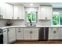 Bright, updated kitchen featuring white cabinets, modern appliances, and a stylish backsplash at 4854 S Parfet St, Littleton, CO 80127
