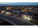 An elevated perspective of the neighborhood showcasing well-lit homes, streets and the community's layout at 14232 Elm St, Thornton, CO 80602