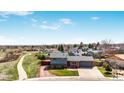 Scenic aerial view of the charming home surrounded by lush greenery and a walking path, showcasing its prime location at 6376 S Estes St, Littleton, CO 80123