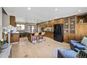 Spacious kitchen with custom cabinetry, granite countertops, black appliances, and central island seating at 6376 S Estes St, Littleton, CO 80123