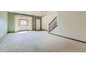 Bright, airy living room featuring neutral paint, plush carpeting, and large windows with abundant natural light at 2585 E Egbert St, Brighton, CO 80601