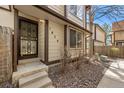 Front entrance featuring a secure black metal door, complementing the home's exterior with landscaped yard at 1829 S Pitkin Cir, Aurora, CO 80017
