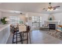 Bright living room with dining area, fireplace, and sliding door to a balcony, perfect for comfortable living at 3260 E 103Rd Pl # 912, Thornton, CO 80229