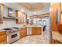 Spacious kitchen featuring custom cabinets, stainless steel appliances, and an island at 848 S Emerson St, Denver, CO 80209