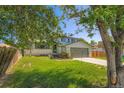 Front exterior of a charming two-story home with a driveway and landscaping at 16623 E Asbury Pl, Aurora, CO 80013