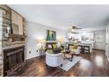 Comfortable living room featuring a stone fireplace and views into the kitchen at 1239 S Flower Cir # C, Lakewood, CO 80232