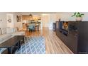 Open-concept living room with hardwood floors and view into kitchen at 777 N Washington St # 508, Denver, CO 80203