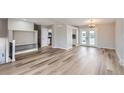 Bright and spacious living area featuring light hardwood floors, and ample space for entertaining at 450 Lone Pine St, Fort Lupton, CO 80621