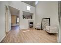 Spacious living room featuring vaulted ceilings, a cozy fireplace, and modern flooring at 10061 Apollo Bay Way, Highlands Ranch, CO 80130