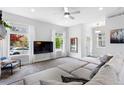 Bright living room featuring large windows, plush seating, and neutral tones at 4589 Quandary Peak St, Brighton, CO 80601