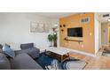 The living room boasts a cozy seating area, hardwood floors, and a modern entertainment setup at 1629 S Deframe St # B8, Lakewood, CO 80228