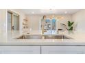 Bright view of a kitchen sink, faucet, and countertops with a pendant light at 1240 S Chase Ct, Lakewood, CO 80232