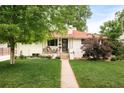 Charming single-Gathering home with a well-manicured lawn and mature landscaping at 5885 S Huron St, Littleton, CO 80120