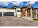 Stunning home with stone accents, wood beams, a two-car garage, and a large driveway at 5820 Powell Rd, Parker, CO 80134