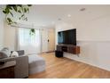 Bright living room featuring hardwood floors, a modern TV setup and comfortable furniture at 4994 S Independence Way, Littleton, CO 80123