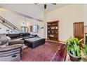 Bright living room featuring high ceilings, large windows, and a stylish leather sofa at 17076 Foxton Dr, Parker, CO 80134
