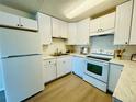 Modern kitchen with white cabinetry, stainless steel appliances, and bright lighting at 755 S Alton Way # 12C, Denver, CO 80247