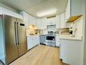 Bright kitchen featuring stainless steel appliances, white cabinetry, and ample countertop space at 755 S Alton Way # 12C, Denver, CO 80247
