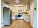 Bright kitchen featuring stainless steel appliances, white cabinetry, and ample countertop space at 755 S Alton Way # 12C, Denver, CO 80247