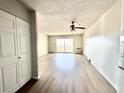 Open-concept living room with sliding glass doors and modern flooring at 755 S Alton Way # 12C, Denver, CO 80247