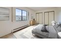 Bright bedroom with large window, closet, and neutral decor at 13902 E Marina Dr # 412, Aurora, CO 80014