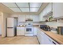Well-lit kitchen with white cabinets and appliances, and ample counter space at 13902 E Marina Dr # 412, Aurora, CO 80014