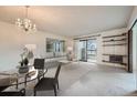 Inviting living room with chandelier, neutral tones, and sliding glass doors to the balcony at 13902 E Marina Dr # 412, Aurora, CO 80014