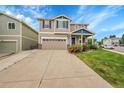 Charming two-story home with a well-manicured lawn and beautiful landscaping at 11091 Clayton St, Northglenn, CO 80233