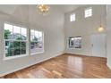Bright living room featuring vaulted ceilings, large windows, and hardwood floors at 11091 Clayton St, Northglenn, CO 80233