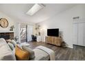 Inviting living room featuring a fireplace, a skylight, and a cozy seating area at 18391 E Kepner Pl # 205, Aurora, CO 80017