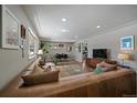 Open concept living room with hardwood floors and dining area at 2753 S Meade St, Denver, CO 80236