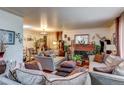 Cozy living room with comfortable sofas, a brick fireplace, and elegant decor at 233 Nome St, Aurora, CO 80010