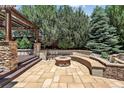 Cozy outdoor patio with built-in seating, a charming fire pit, and landscaped surroundings at 4649 Spinning Wheel Dr, Brighton, CO 80601