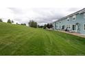 Expansive backyard with lush green grass and a row of townhomes at 19249 E 58Th Ave # D, Denver, CO 80249