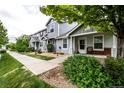 Beautiful townhome with a well-manicured lawn, sidewalk, and a cozy front porch at 19249 E 58Th Ave # D, Denver, CO 80249
