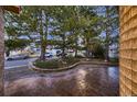 Front yard featuring mature landscaping, decorative rock and stamped concrete at 5461 S Youngfield Ct, Littleton, CO 80127