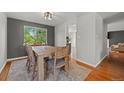 Cozy dining room featuring hardwood floors, a wooden table and natural light from the window at 1716 W Sunset St, Longmont, CO 80501