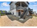 Backyard view with deck, stairs, and sliding glass door. Partially xeriscaped with new growth at 6881 Oak Canyon Cir, Castle Pines, CO 80108