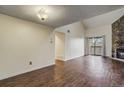 Inviting living room with hardwood floors, a stone fireplace, and a sliding door to a balcony at 218 Wright St # 303, Lakewood, CO 80228