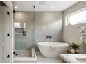 Spa-like bathroom with soaking tub and walk-in shower at 2664 S Cherokee St, Denver, CO 80223