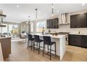 Modern kitchen with dark cabinetry, quartz countertops, and island at 2664 S Cherokee St, Denver, CO 80223