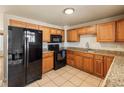 Well-equipped kitchen with tile floors, modern appliances, and ample cabinet space at 8235 Auburn Ln, Westminster, CO 80031