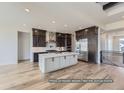 Modern kitchen featuring an island and stainless steel appliances at 9719 Canyon Wind Pt, Parker, CO 80138