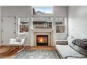 Comfortable living room with a fireplace, natural light, and stylish decor at 12063 Monaco Ct, Brighton, CO 80602