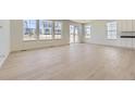 Bright living room with light wood floors, lots of windows, and white cabinets, perfect for relaxing or entertaining at 39867 Floyd St, Elizabeth, CO 80107